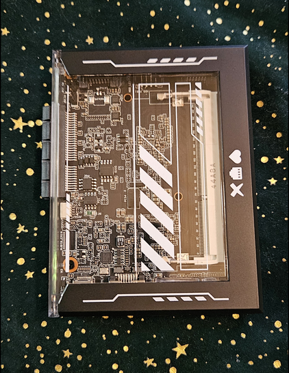 Image of a Zimablade single-board computer. Translucent case with black edges and "danger" striped details.