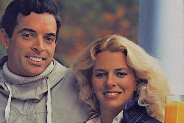 1983 

Two individuals posed together, smiling and looking towards the camera.
The man is on the left and the woman on the right.
They appear to be in an outdoor setting with trees in the background.
Tags: couple, photography, outdoors, smiling, two people