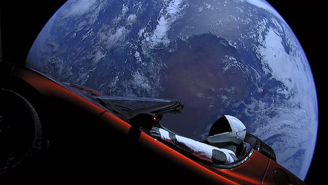 Photograph of SpaceX “Starman” mannequin on a red Tesla Roadster elecric car in orbit around planet Earth, after successful launch and separation from a Falcon Heavy rocket. The red Tesla Roadster vehicle was previously owned by Elon Musk and donated to SpaceX for the mission, which was a technology demonstration launch mission.