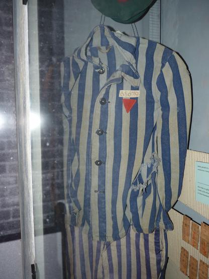 Blue & white striped jacket and (mismatched) trousers: the uniform of a KZ inmate. 

A red triangle on the breast indicates it belonged to a political prisoner.