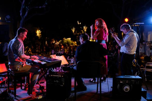 4 musicians on stage. Photo taken from the back of the stage