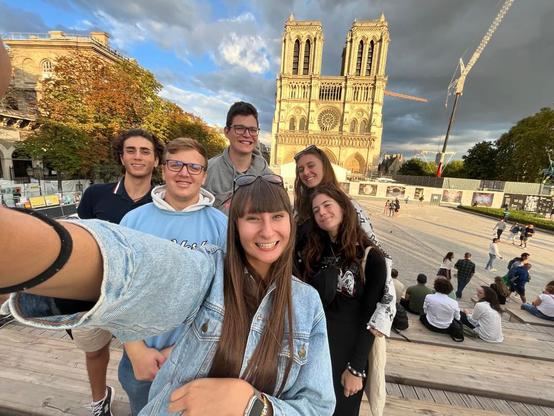 Group of friends taking a selfie in front of Notre-Dame in Paris