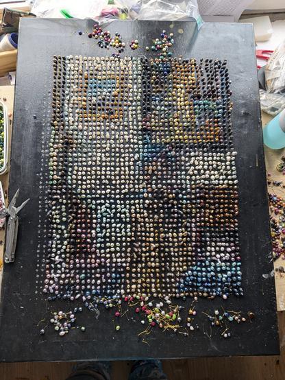 Vermeer's Woman Standing At a Virginal recreated as pixel art using freshwater pearls.