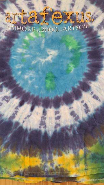 Tie die T shirt, blue green center,  black and white middle orbit, yellow purple green edges.
Title in yellow--'Artafefux'
Baltimore 
ARTSCAPE 
2000