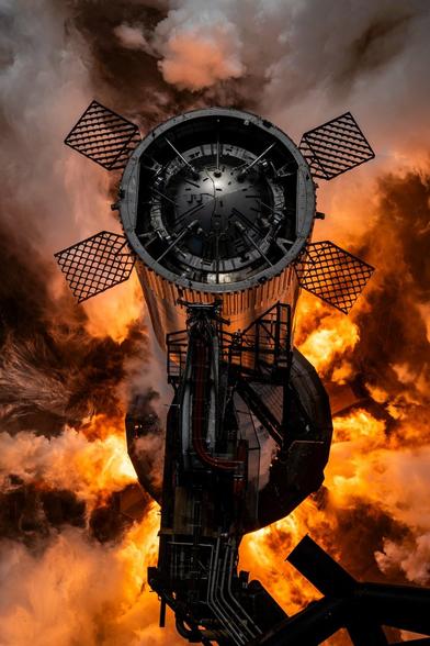 Photo of SpaceX's Starship Super Heavy booster during static fire test. Aerial view.