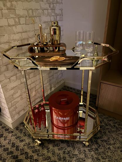 Drinks trolley with red ice bucket.