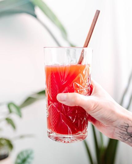 Hand holding a glass of juice