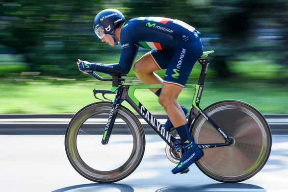A cyclist competes in a time trial, in which a lone cyclist races for the best time on a course.