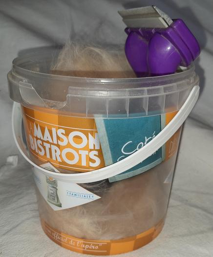 Tub containing a Furminator cat-comb and a lot of pale ginger underfur