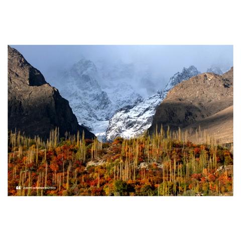 Landscape photo of Hunza valley- in full autumn colors- backgrounded by icy peaks.
