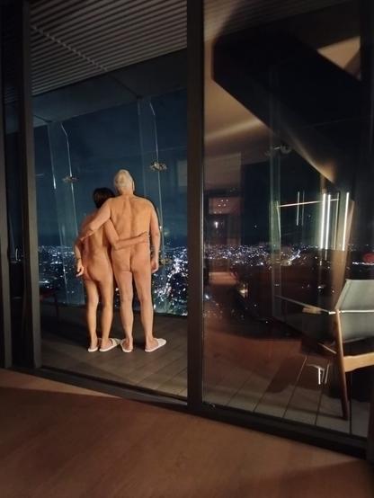 Rosi and Gerardo, nude, facing Mexico City's Chapultepec park in the background.