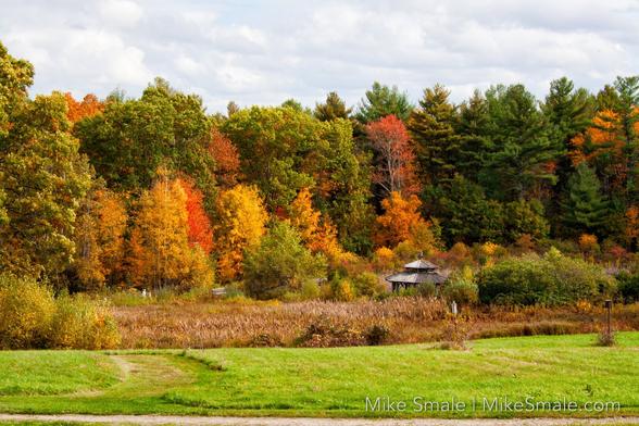 A very distant couple walks the trail to the gazebo.