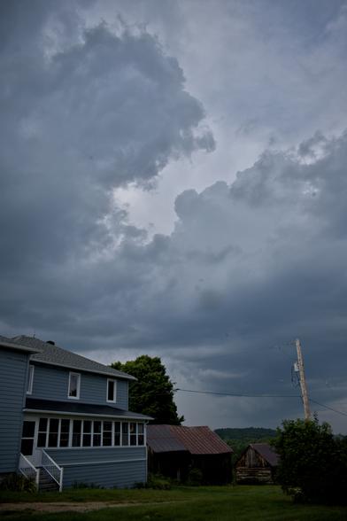 A 1950s farmhouse and older barns (1870s-1920s) under storm clouds yesterday.