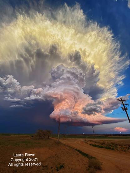 Very large cumulonimbus cloud over farmland.
