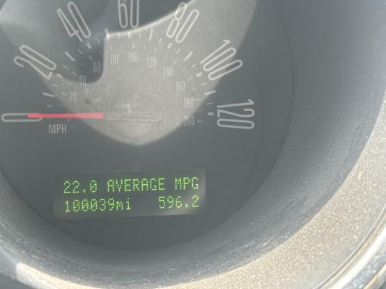 Closeup of odometer reading 100,039 miles.