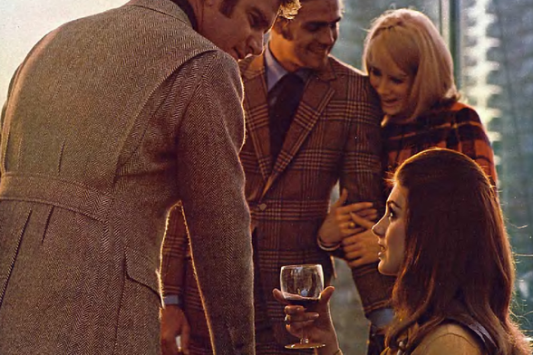 1969 

This image depicts a group of five individuals engaged in social interaction.
They appear to be at an outdoor gathering, possibly enjoying wine and conversation.
The setting sunlight casts a warm glow on the scene, suggesting it might be late afternoon or early evening.
Tags: people, friends, socializing, outdoor gathering, wine, relaxation