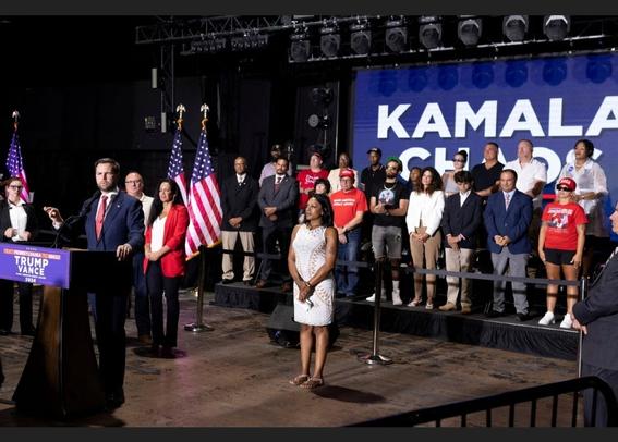 JDVance rally with a huge Kamala Chaos sign behind him, but there are people in front of the word Chaos.