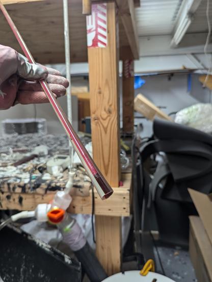 The end of a tube with a transparent pink stripe. You can see the pink phosphor coating making it pop with its white powder. THIS is how tubes with transparent colors should be backed. I am wearing a rubber glove for safety with chemicals :)