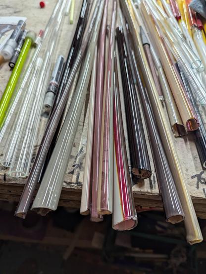 A bunch of hand pulled stripey tubes, phosphor coated, binder burned out and sitting on the table, ready to bend :)