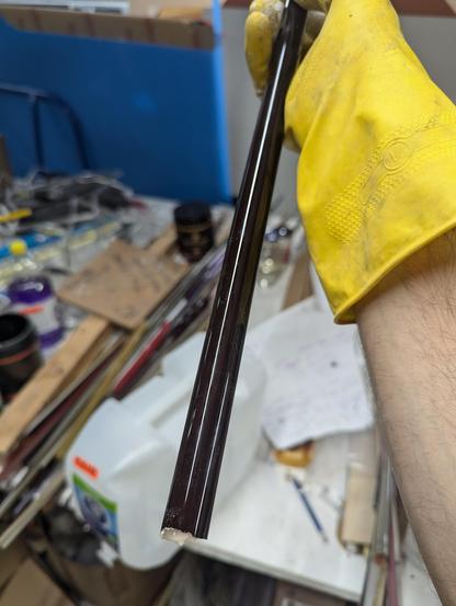 A deep brown tube- so dense with color that it looks black. Exactly how I want it! The warm white phosphor inside will be very bright and be filtered by the densely colored glass. Yellow rubber kitchen glove for safety- that tube is still dripping liquid phosphor suspension.