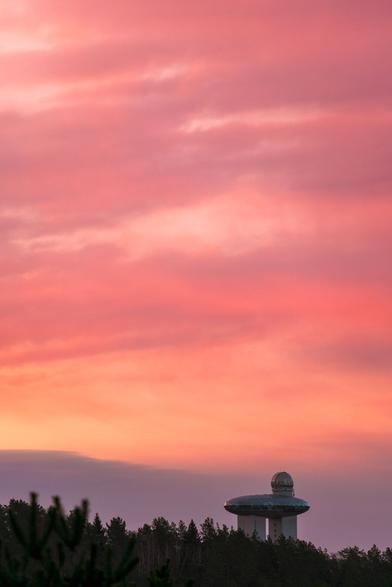 Lithuanian Museum of Ethnocosmology far away with a very vivd pink clouds during sunrise