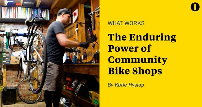 Left: A bicycle is suspended on a bike stand in a small room with bike tools, parts and manuals on the walls, side tables and floor. To the right of the bike stands a man with medium-light skin sorting through objects on a table. Right: Yellow background with text: "WHAT WORKS: The enduring power of community bike shops. By Katie Hyslop."