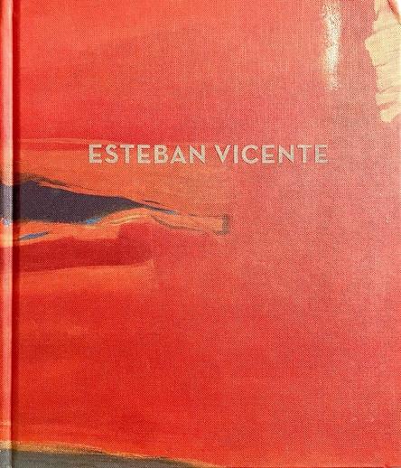 A hardcover exhibition catalog entitled 'Esteban Vicente'. This show took place at the Ameringer McEnery Yohe gallery in Manhattan. A detail of an abstract painting covers the front board in shades of deep orange, black and gray and gold. The name of the artist appears over it in light gray letters.