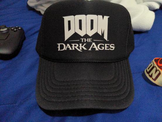 A black hat with the words "Doom The Dark Ages" in white letters.