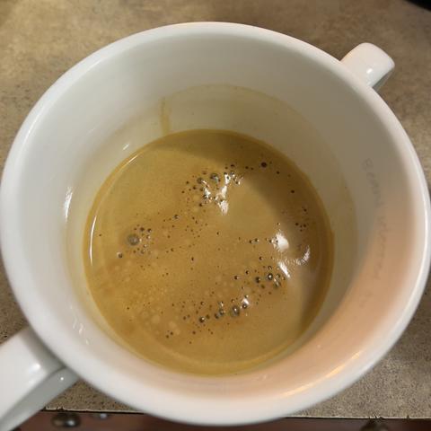 Freshly made espresso shot sitting in a white cafe style cup. 

Green beans from Nosa Familia in #PDX, air roasted at home.