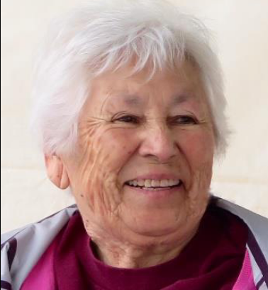 Tillie Fay Walker, late in life, from a 2018 obituary; a smiling older woman with short white hair and tan kin, wearing a dark pink and grey top