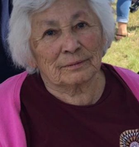 Tillie Fay Walker, late in life; an older woman with short white hair and tan skin, wearing a dark pink and maroon top