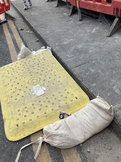 An accessibility ramp at the location of roadworks, where an alternative route for pedestrians has been put in place off the footpath and in the carriageway. The accessibility ramp is off the footpath, leaving a gap and a section of kerb remaining, and defeating the purpose of the ramp entirely.