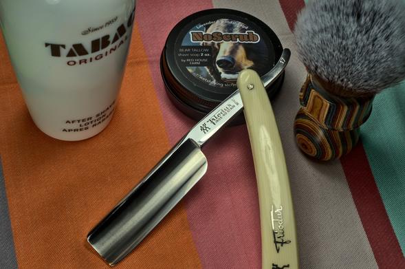 A big Friodur 17 propped up on a tin of RHF NoScrub soap next to a Motherlode brush and a bottle of Tabac splash