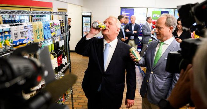 Doug Ford standing in a convenience store chugging a can of something.