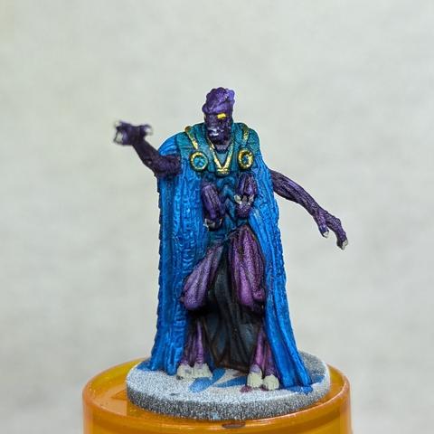 A painted plastic miniature.  It's a four armed purple humanoid alien wearing a blue robe.  The alien is reaching forward aggressively with the of its hands.