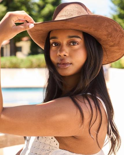 Akilah Releford-Gould looking at the camera, wearing a hat.