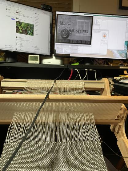 Weaving a silvery scarf in front of a monitor showing arsenic and old lace in a small window