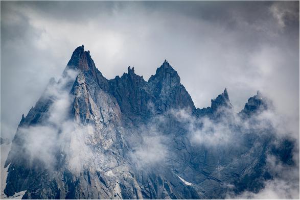 Craggy pointed pinnacles rising out of the clouds.