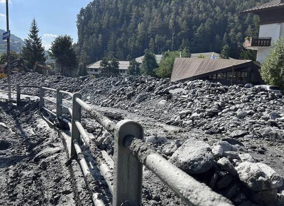 photo - August 14th 2023 - "Streets and cars in Bardonecchia, a city near Turin in the Val di Susa mountain valley, were coated in thick, grey sludge following the violent mudslides late on Sunday."