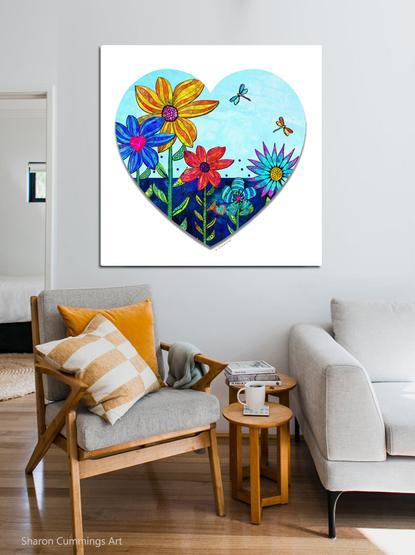 Colorful flowers and dragonflies in a heart shape by artist Sharon Cummings.