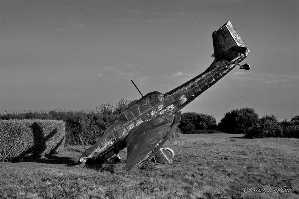 monochrome picture of the stainless steel scuplture of a german STUKA crashing to the ground at the Battle of Britain Memorial in Capel-Le-Ferne