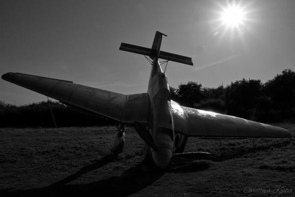 monochrome picture of the stainless steel scuplture of a german STUKA crashing to the ground at the Battle of Britain Memorial in Capel-Le-Ferne