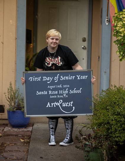 Senior picture of boy with sign