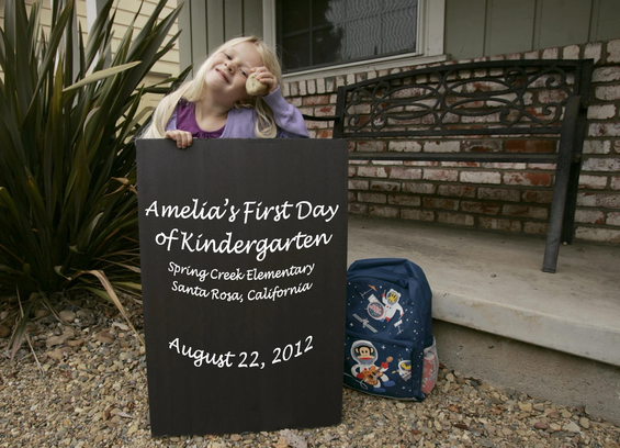 Kindergarten picture of kid with sign.