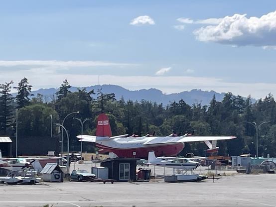 A closeup of the Hawaii Mars amongst some small amphibious planes.