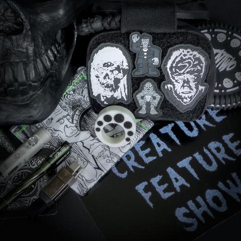 photograph of a black and white creature/monster themed EDC