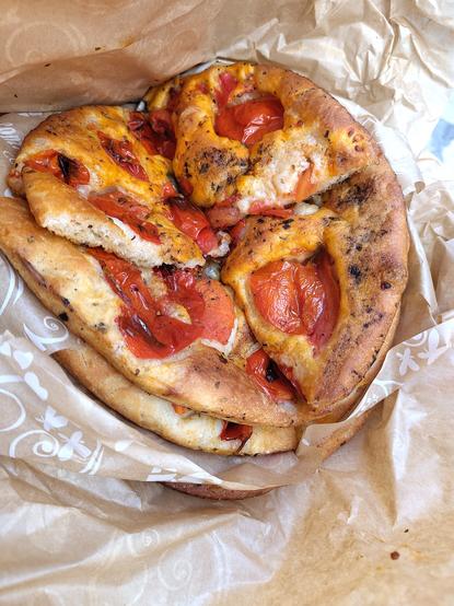 Focaccia barese with pomodorini,  one on top of the other and cut into quarters.