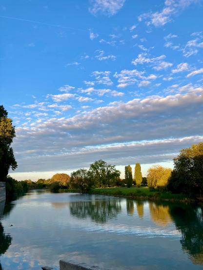 Image i took in France. There’s a lake and some trees. The sky is above, reflecting on the lake