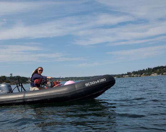 ASV in Zodiac boat with bright pink ball float marker.