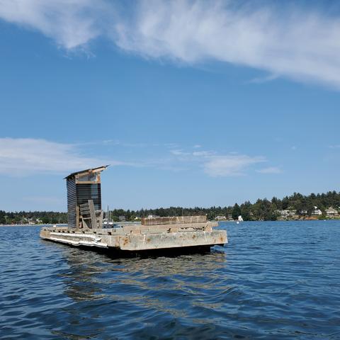 A floating dock with bench & covered seated area. Used for official racing events.